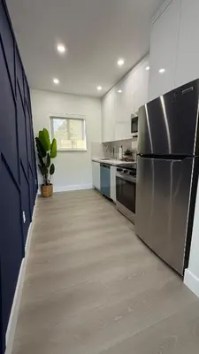 a kitchen with a stainless steel refrigerator and cabinets at 78 Tropical soak in Miami