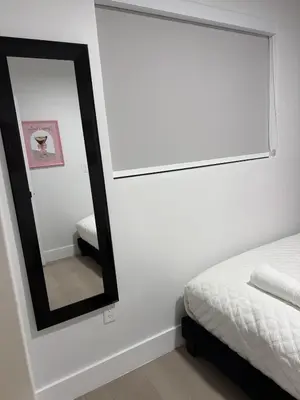 a bedroom with a mirror next to a bed at 78 Tropical soak in Miami
