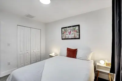 a white bedroom with a white bed and a picture on the wall at 397 A - Beautiful Home in Miami in Miami