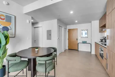 a kitchen and dining room with a table and chairs at Stylish Urban 1BR Downtown Rooftop Pool & Views in Miami