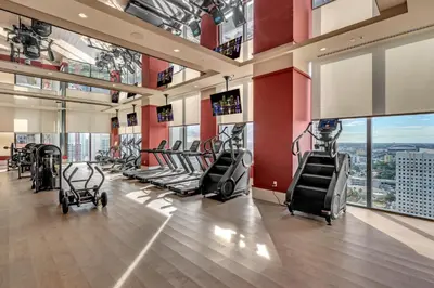 a gym with treadmills and ellipticals in a building at Stylish Urban 1BR Downtown Rooftop Pool & Views in Miami