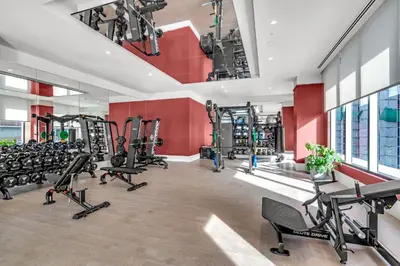 a fitness room with treadmills and tread machines at Stylish Urban 1BR Downtown Rooftop Pool & Views in Miami