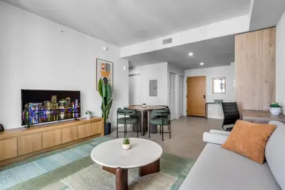a living room with a couch and a table at Stylish Urban 1BR Downtown Rooftop Pool & Views in Miami