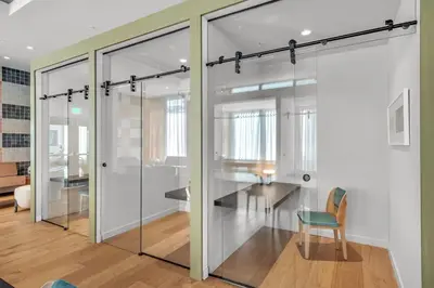 a room with glass doors and a chair at Stylish Urban 1BR Downtown Rooftop Pool & Views in Miami