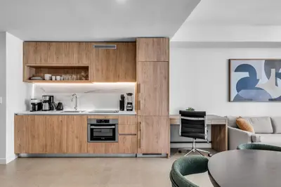 a kitchen with a sink and a table in a room at Stylish Urban 1BR Downtown Rooftop Pool & Views in Miami