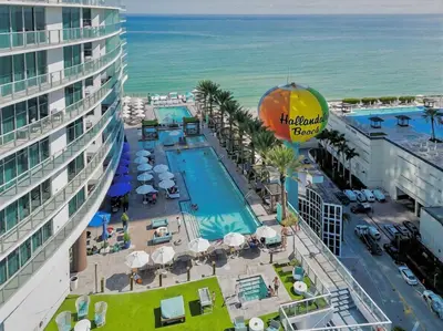 an aerial view of a resort with a pool and the ocean at Prime Oceanfront 3BR Mansion in the Sky in Hollywood