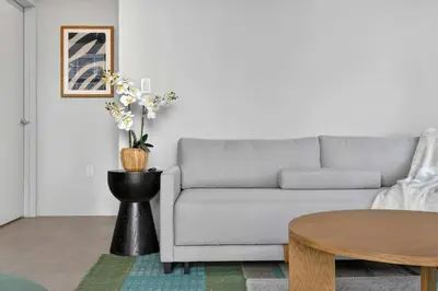 a living room with a couch and a table at The Crosby Miami Worldcenter Downtown Miami in Miami