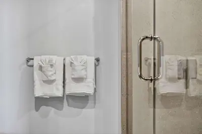 a bathroom with white towels hanging on a towel rack at The Crosby Miami Worldcenter Downtown Miami in Miami