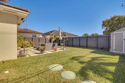 a backyard with a fence and some frisbees on the grass at Easy Park and University Access! Family Miami Escape in Miami