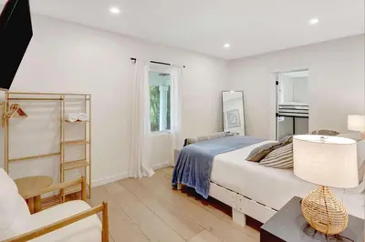 a bedroom with a bed and a desk and a chair at Casa in Tropic Paradise with Pool and BBQ in Biscayne Park