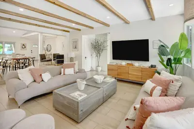 a living room with couches and a flat screen tv at Casa in Tropic Paradise with Pool and BBQ in Biscayne Park