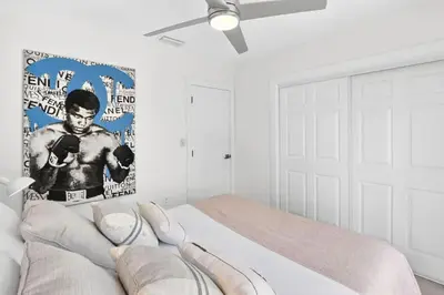 a bedroom with a boxing poster on the wall at Spacious Miami 4BR Retreat with Pool & BBQ in Miami
