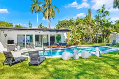 a backyard with a swimming pool and a house at Spacious Miami 4BR Retreat with Pool & BBQ in Miami