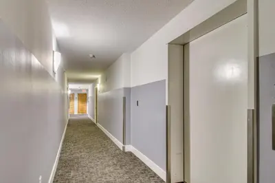 an empty hallway with white walls and a door at Luxe Miami Vice Condo! Bay Views and Pool Access in Miami