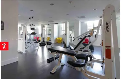 a gym with several tread machines in a room at Downtown Apartment with free parking near Brickell in Miami