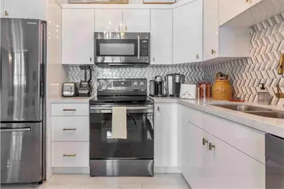 a kitchen with a stove and a microwave at Downtown Apartment with free parking near Brickell in Miami