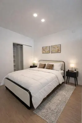 a large white bedroom with a large bed and two tables at Prime Miami location - Modern Skyline Stay in Miami