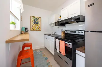 a kitchen with a stove and a refrigerator at Tropical Retreat with Private Yard, Fire Pit, Hammock in Hollywood