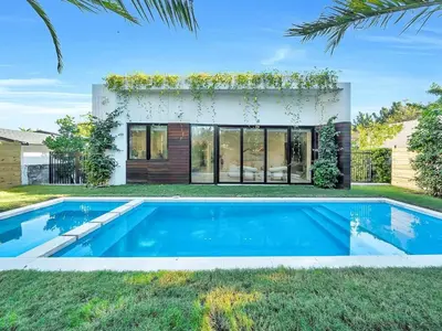 a swimming pool in front of a house at Luxury Pool Home - Downtown Brickell in Miami