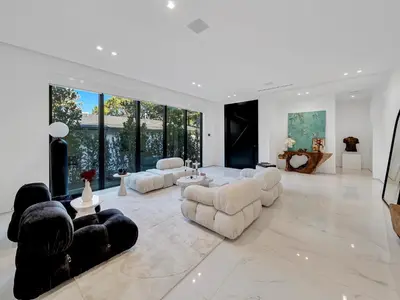 a large living room with white furniture and large windows at Luxury Pool Home - Downtown Brickell in Miami