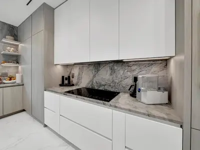 a kitchen with white cabinets and a counter top at Luxury Pool Home - Downtown Brickell in Miami
