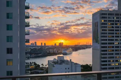 a sunset seen from a balcony of a city at Miami Bay Million-Dollar View | Private Condo in Miami