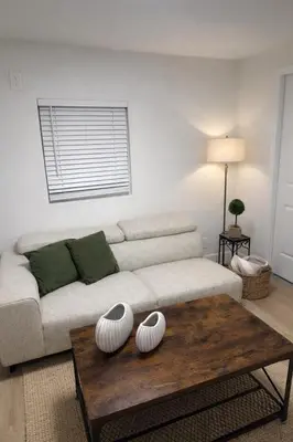 a living room with a couch and a coffee table at Fort Lauderdale Airport Pacifica Lake Bleu in Dania Beach