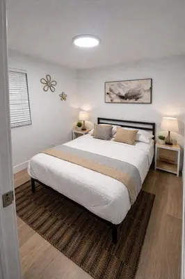 a bedroom with a large bed with two night stands at Fort Lauderdale Airport Pacifica Lake Bleu in Dania Beach