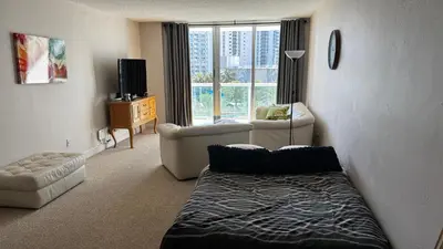 a living room with a bed and a couch at Ocean Reserve Miami Luxury Rentals in Sunny Isles Beach