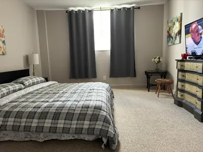 a bedroom with a bed and a television and a window at Ocean Reserve Miami Luxury Rentals in Sunny Isles Beach