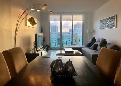 a living room with a couch and a table at Penthouse Ocean Reserve in Miami Beach