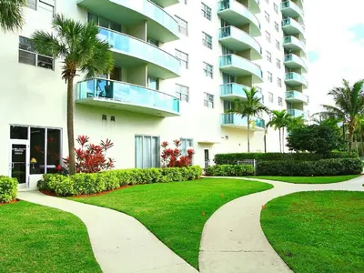 a walkway in front of a large apartment building at Penthouse Ocean Reserve in Miami Beach