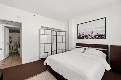 a bedroom with a bed and a picture on the wall at Casa Grande Suites on Ocean Drive in Miami Beach
