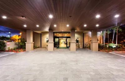 an empty lobby of a building with a wooden ceiling at Holiday Inn Miami West - Airport Area by IHG in Hialeah Gardens