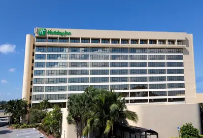 a building with a sign on top of it at Holiday Inn Miami West - Airport Area by IHG in Hialeah Gardens