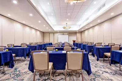 a conference room with blue tables and chairs at Holiday Inn Miami West - Airport Area by IHG in Hialeah Gardens