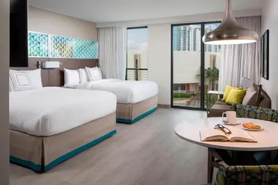 a hotel room with two beds and a table at Residence Inn by Marriott Miami Beach South Beach in Miami Beach