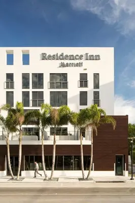 a building with palm trees in front of it at Residence Inn by Marriott Miami Beach South Beach in Miami Beach