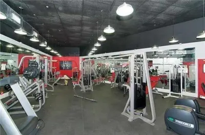 a gym with treadmills and machines in a room at Castle Beach Club Apartments in Miami Beach