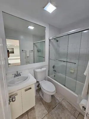 a bathroom with a toilet and a sink and a shower at Castle Beach Club Apartments in Miami Beach