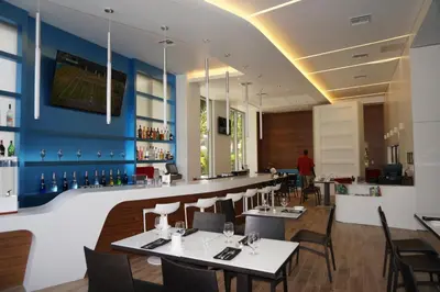 a restaurant with tables and chairs and a bar at Beachwalk Resort Residence in Hollywood