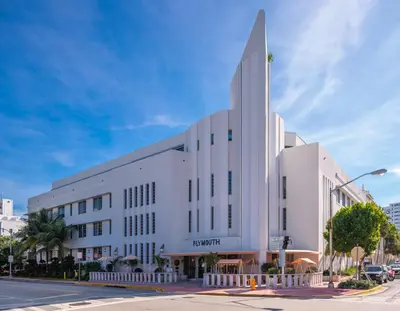 a large white building on a city street at The Plymouth South Beach in Miami Beach