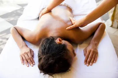 a man laying on a bed getting a massage at The Plymouth South Beach in Miami Beach