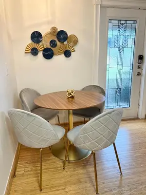 a dining room with a table and four chairs at Harmonious Suites in North Miami Beach