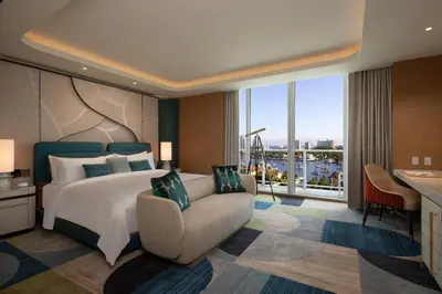 a bedroom with a bed and a couch and a window at Pier Sixty-Six in Fort Lauderdale
