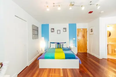 a bedroom with a bed with a colorful bedspread at Hudson Apartments in Miami Beach