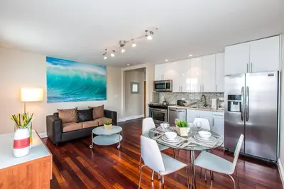 a kitchen and living room with a table and a couch at Hudson Apartments in Miami Beach