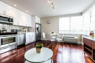 a kitchen with white appliances and a table and chairs at Hudson Apartments in Miami Beach