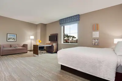 a large hotel room with a bed and a desk at Hampton Inn & Suites Fort Lauderdale - Miramar in Miramar