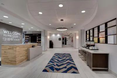 a lobby of a store with a welcome rug at Hampton Inn & Suites Fort Lauderdale - Miramar in Miramar